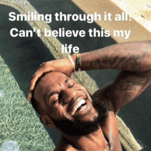 A Man Is Smiling In A Pool With The Words Smiling Through It All Can 'T Believe This My Life GIF