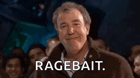 A Man Is Smiling In Front Of A Crowd Of People And Saying `` Ragebait '' . GIF