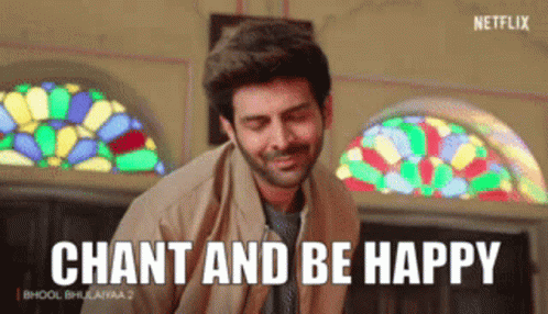 A Man Is Smiling In Front Of A Stained Glass Window And Says Chant And Be Happy GIF