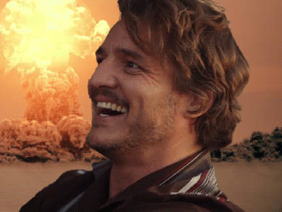 A Man Is Smiling In Front Of An Explosion GIF