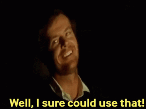 A Man Is Smiling In The Dark With The Words `` Well , I 'M Sure Could Use That '' Behind Him . GIF