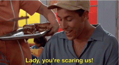A Man Is Smiling While A Woman Holds A Tray Of Food And Says Lady You 'Re Scaring Us .. GIF