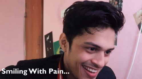 A Man Is Smiling With Pain Written Below Him GIF