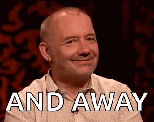 A Man Is Smiling With The Words " And Away " Above Him GIF