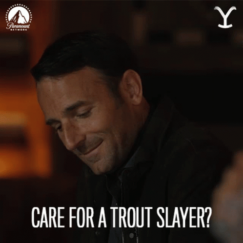 A Man Is Smiling With The Words Care For A Trout Slayer Above Him GIF