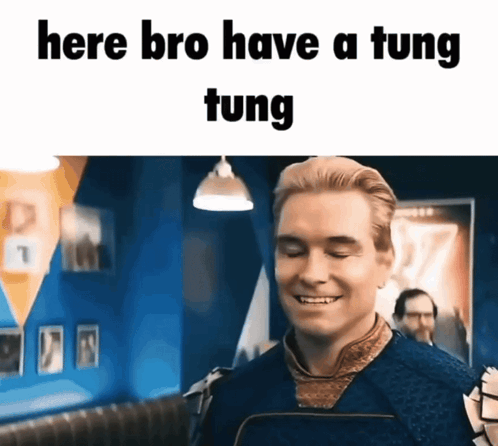 A Man Is Smiling With The Words Here Bro Have A Tung Tung Written Above Him GIF