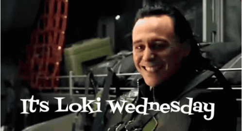 A Man Is Smiling With The Words " It 'S Loki Wednesday " Behind Him GIF