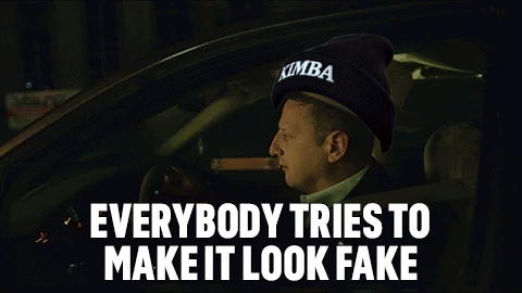 A Man Is Smoking A Cigar While Driving A Car With The Words Everybody Tries To Make It Look Fake . GIF