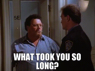 A Man Is Smoking A Cigarette And Talking To A Police Officer In A Doorway . GIF