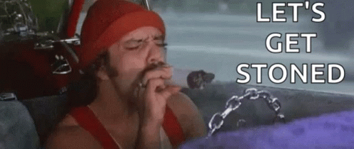 A Man Is Smoking A Cigarette In A Car With The Words `` Let 'S Get Stoned '' Written On The Bottom . GIF