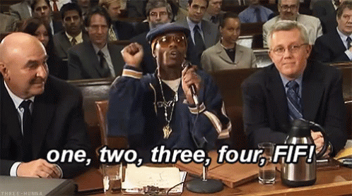 A Man Is Speaking Into A Microphone In Front Of A Crowd And The Words One , Two , Three , Four , Fif GIF