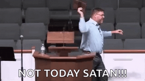 A Man Is Standing At A Podium Holding A Bible And Saying `` Not Today Satan '' . GIF