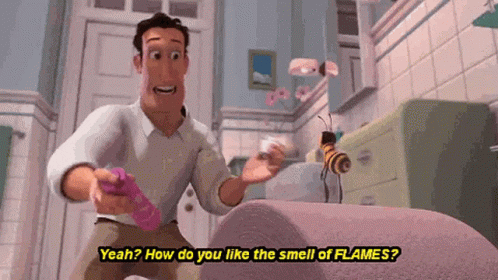 A Man Is Standing In A Bathroom Talking To A Bee While Holding A Remote Control . GIF