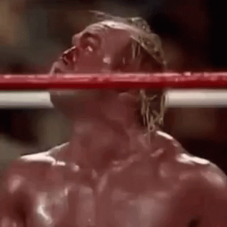 A Man Is Standing In A Boxing Ring With Blood Coming Out Of His Eyes . GIF