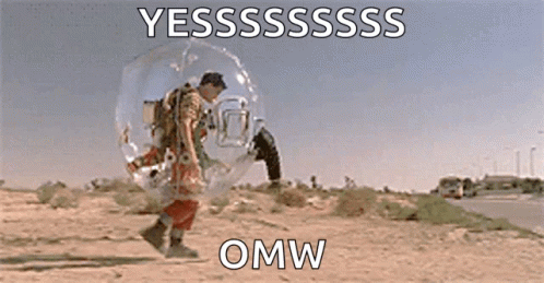 A Man Is Standing In A Bubble In The Desert With A Bird On His Back . GIF