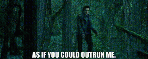 A Man Is Standing In A Dark Forest With The Words As If You Could Outrun Me GIF