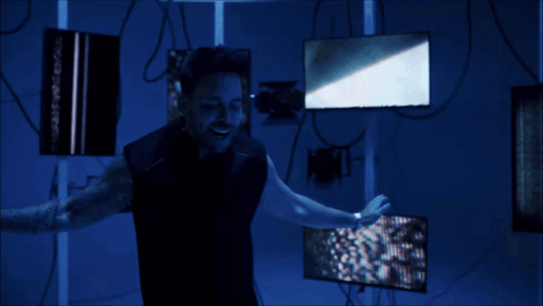 a man is standing in a dark room holding a light