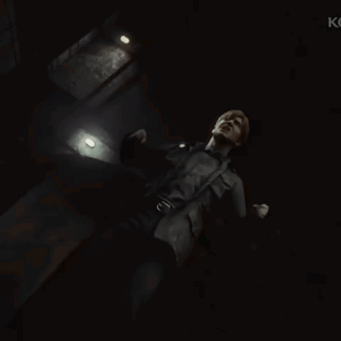 A Man Is Standing In A Dark Room With The Letter K On The Bottom Right GIF