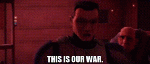 A Man Is Standing In A Dark Room With The Words `` This Is Our War '' Written On It . GIF