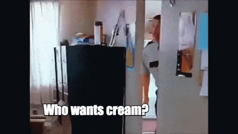 A Man Is Standing In A Doorway Asking Who Wants Cream . GIF