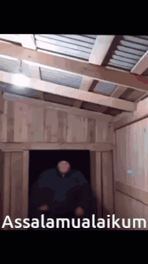A Man Is Standing In A Doorway With The Words Assalamualaikum Written On The Bottom GIF