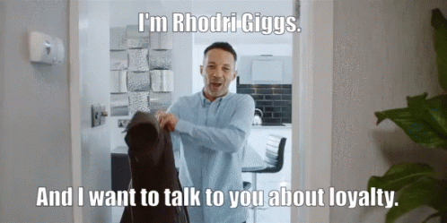 A Man Is Standing In A Doorway With The Words I 'M Rhodri Giggs GIF