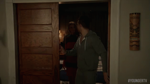 A Man Is Standing In A Doorway With #Youngertv Written On The Bottom Of The Screen GIF