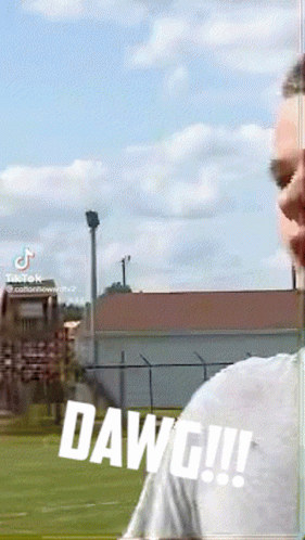 A Man Is Standing In A Field With The Word Dawg Written On The Bottom GIF