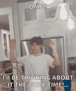 A Man Is Standing In A Kitchen With His Arms In The Air And A Sink . GIF