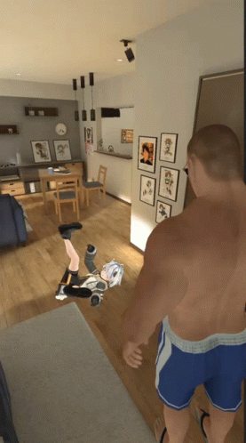 A Man Is Standing In A Living Room With A Girl On The Floor GIF