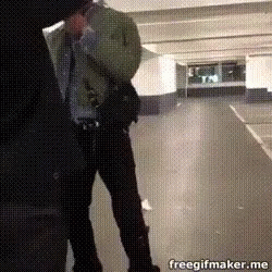 A Man Is Standing In A Parking Garage With A Freegifmaker.me Logo In The Corner GIF