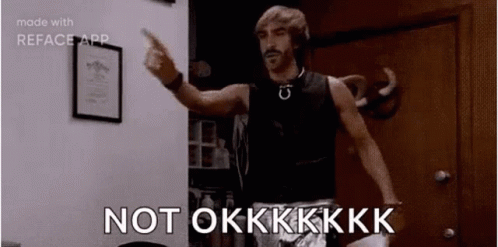 A Man Is Standing In A Room Pointing At The Camera And Saying `` Not Okkkk '' . GIF