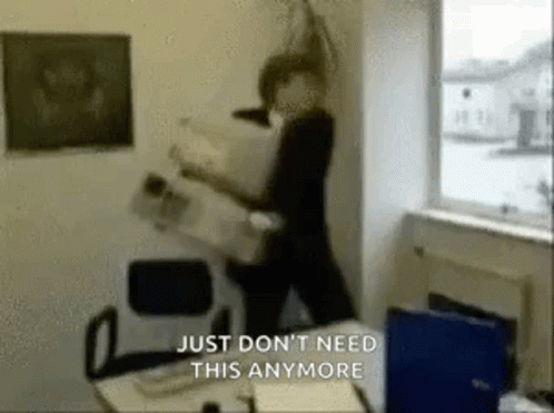 A Man Is Standing In A Room With A Newspaper In His Hand And The Words `` Just Don 'T Need This Anymore '' . GIF