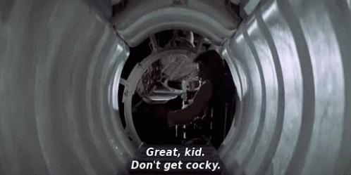 A Man Is Standing In A Tunnel And Talking To Another Man . GIF