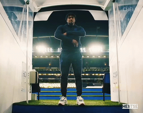 A Man Is Standing In A Tunnel That Says Heitse On The Bottom GIF