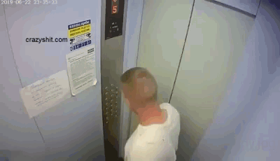 A Man Is Standing In An Elevator With A Sign On The Wall That Says ' Warning ' GIF