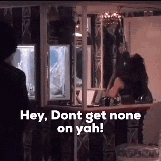 A Man Is Standing In Front Of A Bar With The Words `` Hey , Don T Get None On Yah '' . GIF