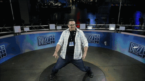 A Man Is Standing In Front Of A Bizzard Sign GIF