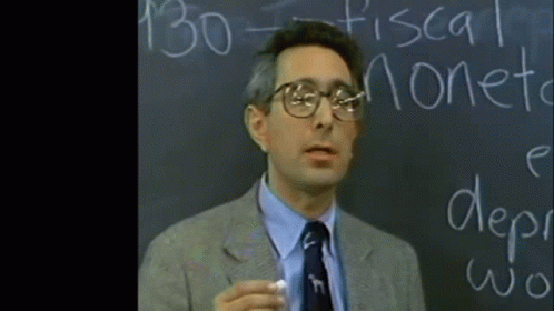 A Man Is Standing In Front Of A Blackboard That Says 130 Fiscal Moneta GIF