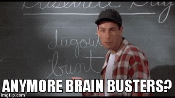 A Man Is Standing In Front Of A Blackboard With Writing On It . GIF