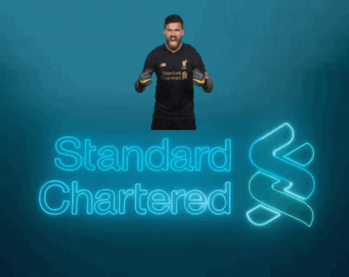 A Man Is Standing In Front Of A Blue Background That Says Standard Chartered GIF