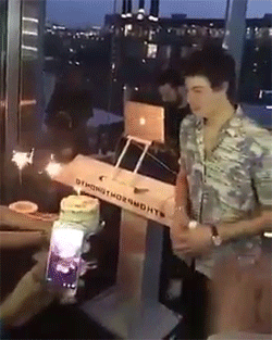 A Man Is Standing In Front Of A Box That Says ' Oymond Thornworth ' On It GIF