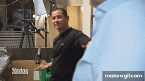 A Man Is Standing In Front Of A Box That Says Rosin 'S GIF