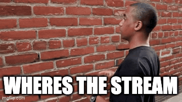 A Man Is Standing In Front Of A Brick Wall And Says Where 'S The Stream GIF