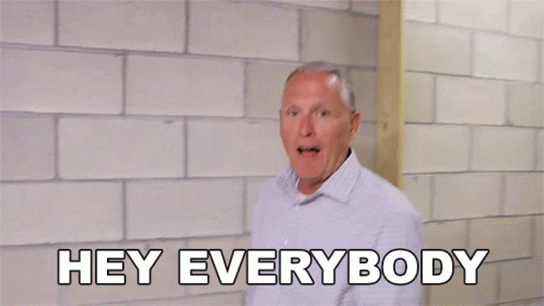 A Man Is Standing In Front Of A Brick Wall With His Arms Outstretched And Says Hey Everybody GIF