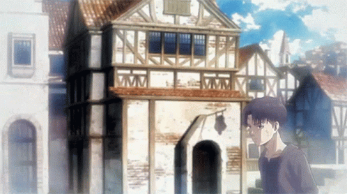 A Man Is Standing In Front Of A Building With A Clock On It GIF