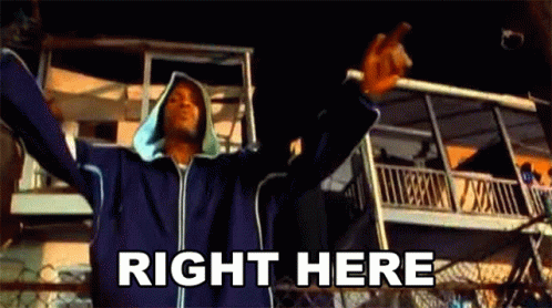 A Man Is Standing In Front Of A Building With His Arms Outstretched . GIF