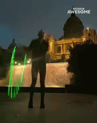 A Man Is Standing In Front Of A Building With The Words Awesome On The Bottom GIF