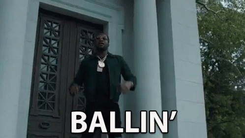 Man Standing In Front Of Building With Ballin On Door GIF