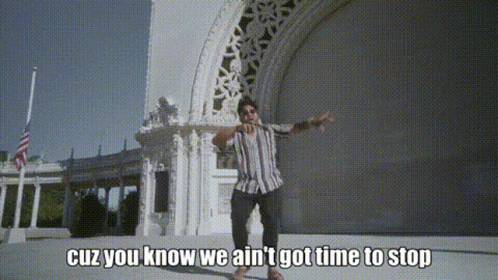A Man Is Standing In Front Of A Building With The Words " Cuz You Know We Ain 'T Got Time To Stop " GIF